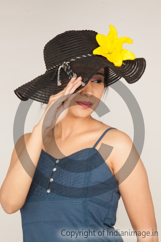 Girl posing with a hat