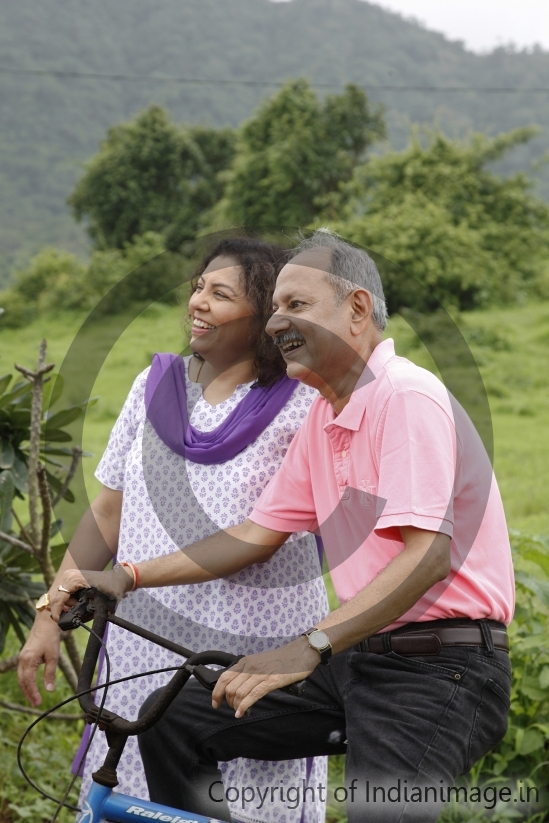 Elderly couple riding cycle