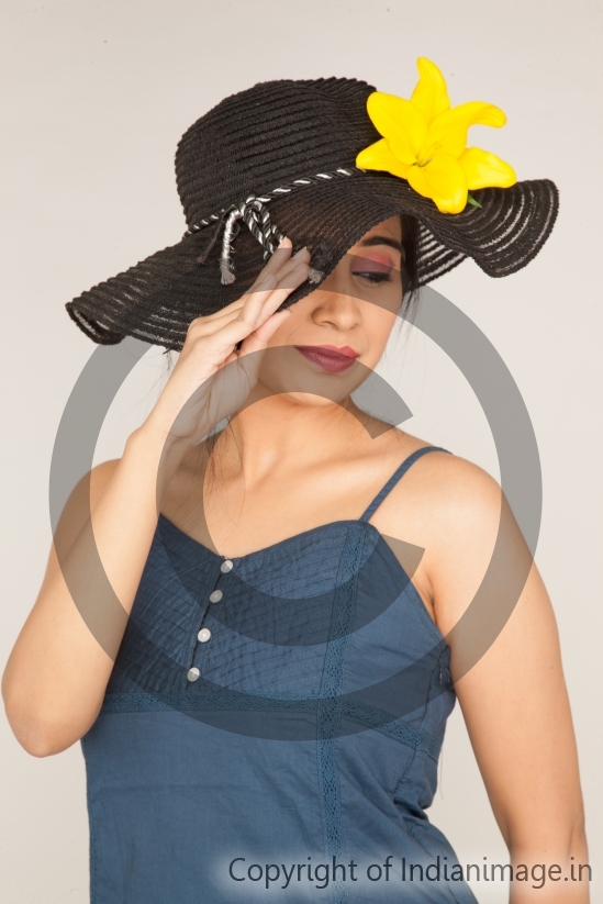 Young girl posing with a hat