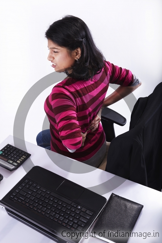 Girl having lower back pain in Office